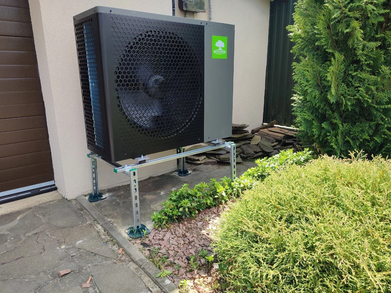Wärmepumpe Mycond BeeHeat neben einem Haus